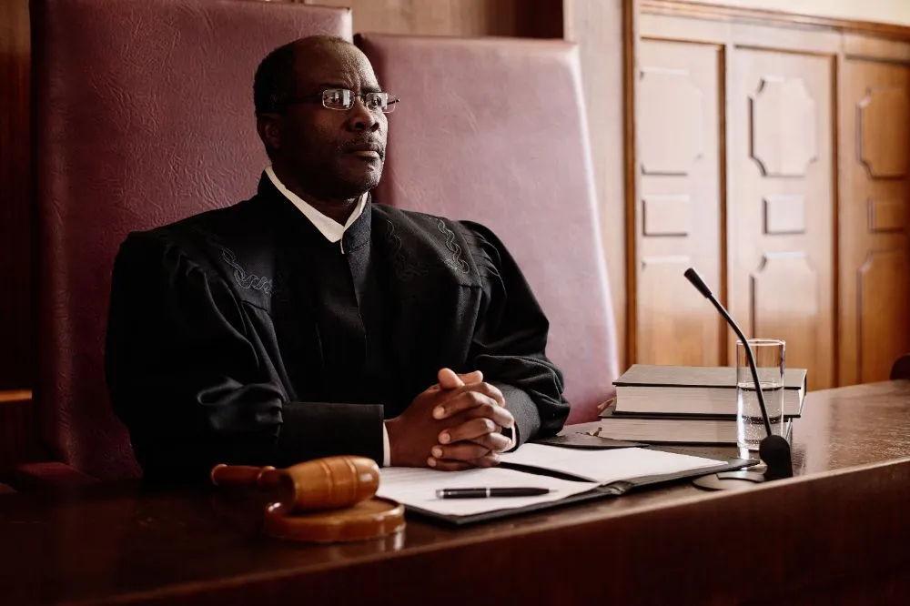 male judge sitting at desk